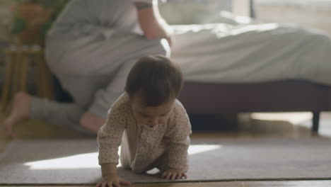 Adorable-Little-Baby-In-Pajamas-Crawling-On-Floor-At-Home
