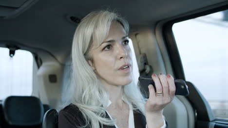 Business-Woman-Recording-Voice-Message-In-A-Car