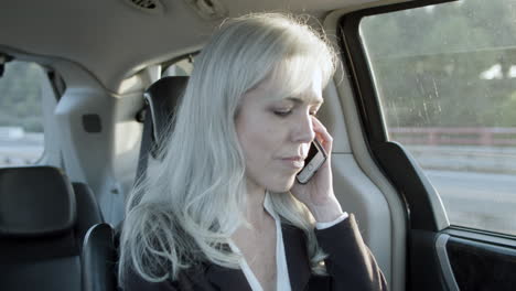 Woman-Talking-On-Phone-In-A-Car