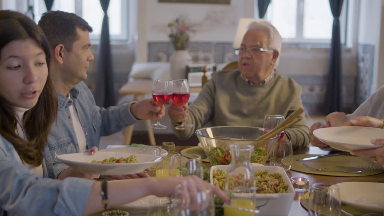 Premium stock video - Happy family sitting at table in dining room ...