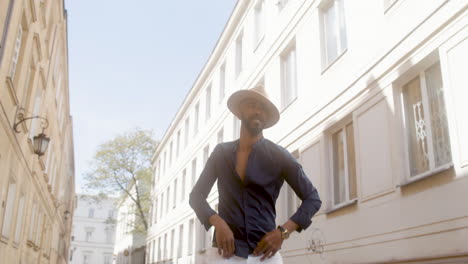 Happy-Afro-Caribbean-Man-With-Panama-Hat-Dancing-Latin-Dance-Alone-In-The-Old-Town-Street-1