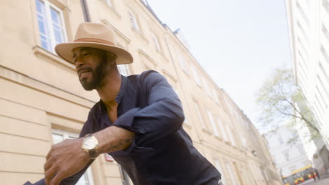 Happy-Afro-Caribbean-Man-With-Panama-Hat-Dancing-Latin-Dance-Alone-In-The-Old-Town-Street-3