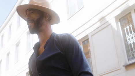 Happy-Afro-Caribbean-Man-With-Panama-Hat-Dancing-Latin-Dance-Alone-In-The-Old-Town-Street-4