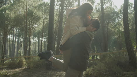Romantic-Young-Couple-Hugging-In-The-Forest