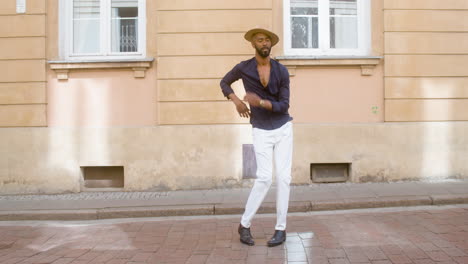 Happy-Afro-Caribbean-Man-With-Panama-Hat-Dancing-Latin-Choreographies-Alone-In-Street-2