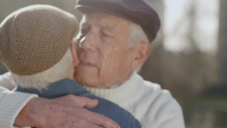 Close-Up-Of-A-Lovely-Senior-Man-In-Grey-Beret-Embracing-His-Wife-Outdoors-On-Autumn-Day-In-Park
