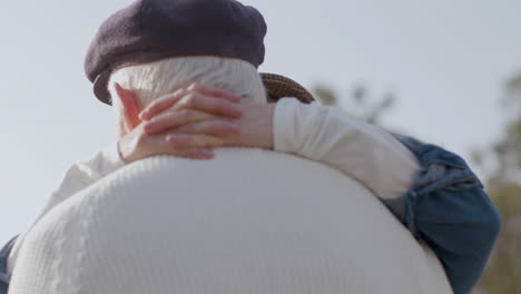 Close-Up-Shot-Of-Loving-Elderly-Couple-Dancing-Outdoors-And-Kissing-In-City-Park