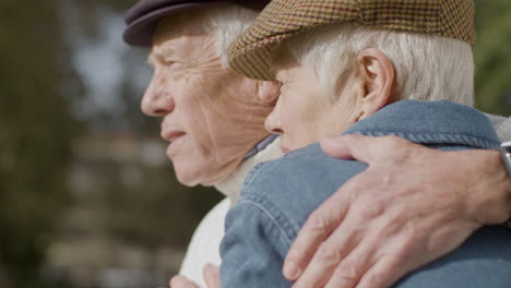 Close-Up-Of-An-Elderly-Couple-Hugging-And-Kissing-While-Spending-Time-In-Park-On-Sunny-Autumn-Day