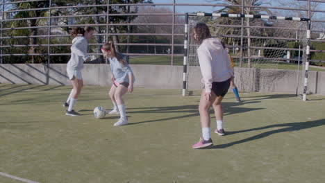 Four-Teenagers-Girls-Playing-Soccer-At-Outdoors-And-Scores