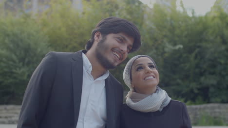 Happy-Arabic-Couple-Standing-Outdoor-And-Looking-At-Each-Other