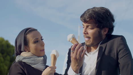 Cheerful-Arabic-Couple-Eating-Ice-Cream-Outdoors-And-Talking