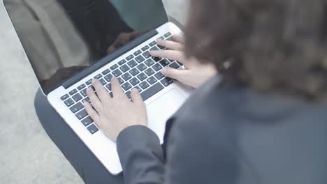 Cropped-Shot-Of-Hands-Of-Businesswoman-Sitting-Outside-And-Typing-On-Laptop-Computer,-Then-Making-Winner-Gesture