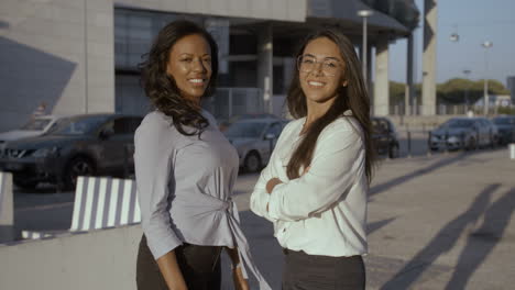 Black-Woman-Smiling-And-Posing-With-Her-Colleague-With-Crossed-Arms