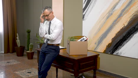 Worried-Man-After-His-Resignation-With-His-Personal-Stuff-On-A-Box