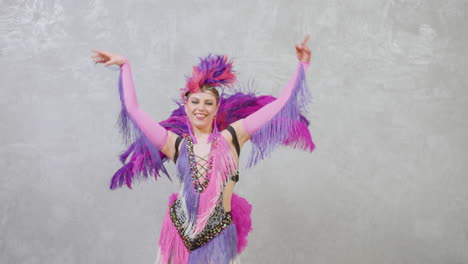 Zoom-Out-View-Of-Pretty-Female-Dancer-In-A-Purple-And-Pink-Feather-Gown