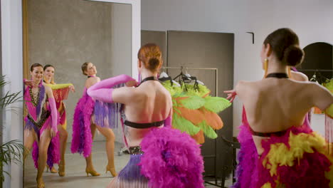 Three-Latin-Dancers-Doing-Rehearsals-Of-The-Cabaret-Dance-In-Front-Of-A-Mirror