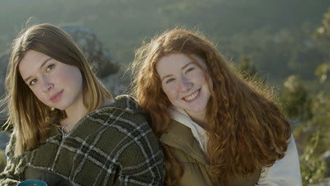 Portrait-Of-Two-Girls-Talking-And-Laughing-Outdoors,-Then-Looking-At-Camera-And-Smiling