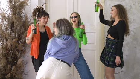 Group-Of-Four-Happy-Girl-Friends-Holding-Beer-And-Dancing-During-A-Party-At-Home-1