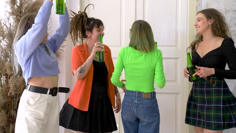 Group-Of-Four-Happy-Girl-Friends-Holding-Beer-And-Dancing-During-A-Party-At-Home-3
