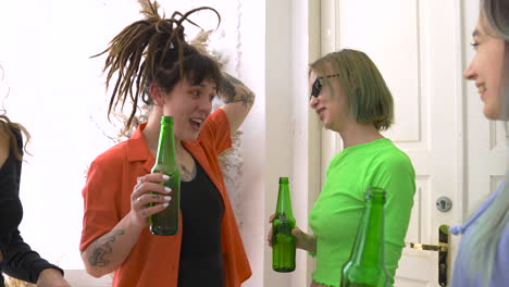 Group-Of-Four-Happy-Girl-Friends-Drinking-Beer,-Talking-And-Dancing-At-Home-1