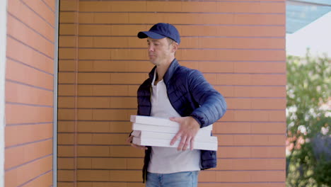 Delivery-Man-With-Pizza-Knocking-On-Door-Of-Customer's-House