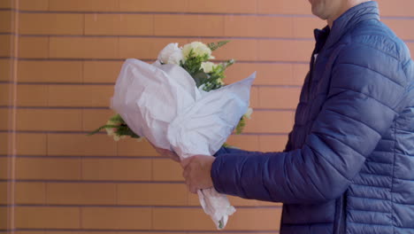 Courier-Delivering-Bouquet-Of-Flowers-To-A-Mature-Woman-At-Her-Home