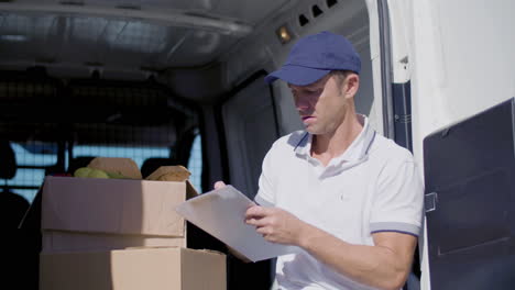 Concentrated-Delivery-Man-Sitting-In-Van-And-Counting-Goods