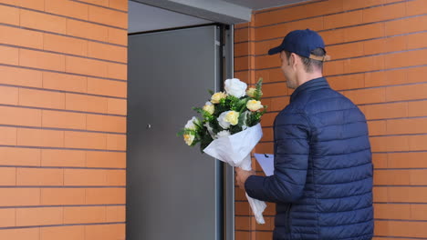 Woman-Opening-Entrance-Door,-Receiving-Flowers-From-Courier-And-Signing-Paper