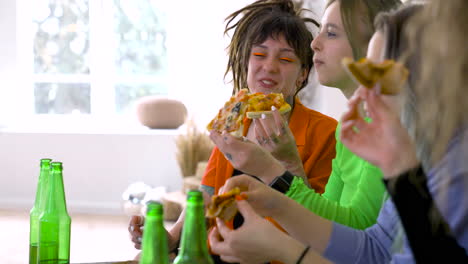 Side-View-Of-Girl-Friends-Talking,-Laughing-And-Eating-Pizza-On-A-Daytime-Party