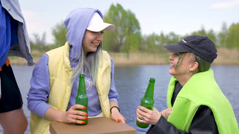 Young-Friends-Having-Fun-Outdoors,-Drinking-Beer