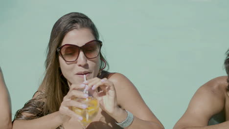 Slider-Shot-Of-Cute-People-Standing-In-Swimming-Pool-And-Talking-With-Beverages