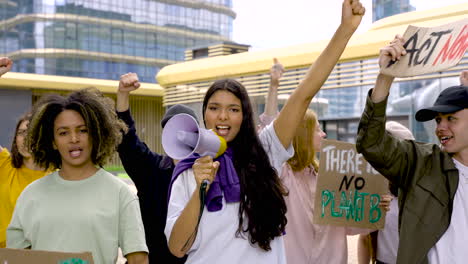 Girl-Holding-Megaphone-Next-To-Her-Colleagues,-Protesting-About-Pollution
