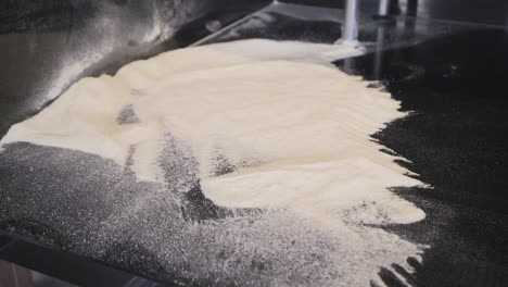 Close-Up-View-Of-Flour-On-A-Large-Black-Countertop
