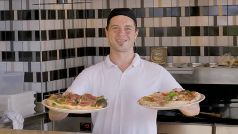 Happy-Chef-Showing-Pizzas-And-Smiling-At-The-Camera-In-The-Restaurant-1