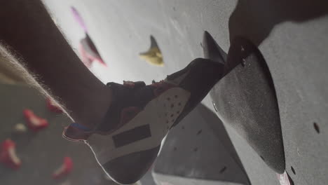 Close-Up-Shot-Of-An-Unrecognizable-Male-Sportsman-Climbing-Up-Bouldering-Wall-Indoors