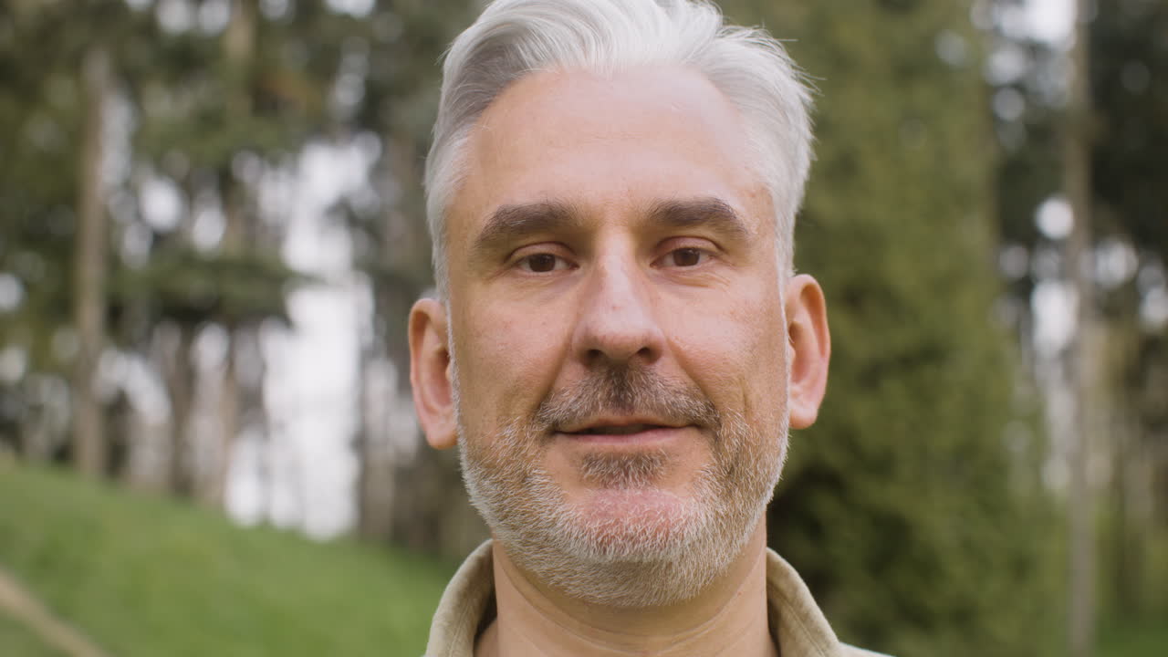 Free stock video - Portrait of a gray haired man standing in the park ...