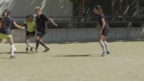Long-Shot-Of-Sportswomen-Playing-Football-On-The-Field