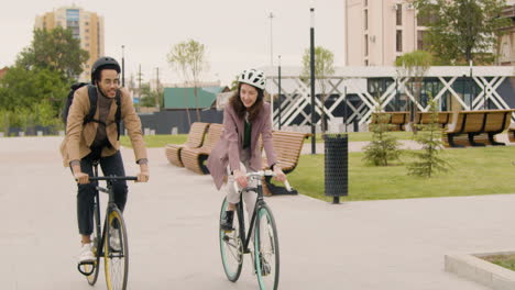 American-Man-And-Woman-Riding-Bikes-And-Talking-To-Each-Other-While-Going-To-Work-3