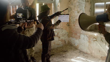 Production-Team-And-Cameraman-Recording-The-Scene-Of-A-Girl-Trying-To-Escape-Through-The-Window-Of-A-Ruined-Building