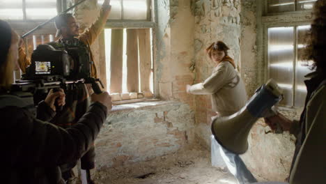 Production-Team-And-Cameraman-Recording-The-Scene-Of-A-Girl-Trying-To-Escape-Through-The-Window-Of-A-Ruined-Building-1