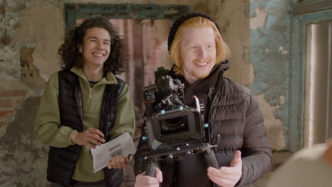 Production-Worker-And-Cameraman-Closely-Recording-A-Girlâ€šÃ„Ã´s-Face-During-A-Scene-In-A-Ruined-Building-1
