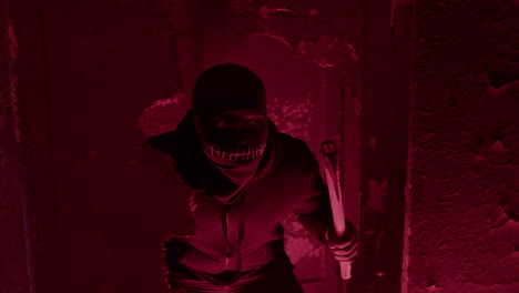 Expectant-Man-Wearing-Black-Balaclava,-Holding-An-Ax-And-Hidden-Behind-A-Wall-In-A-Ruined-Building