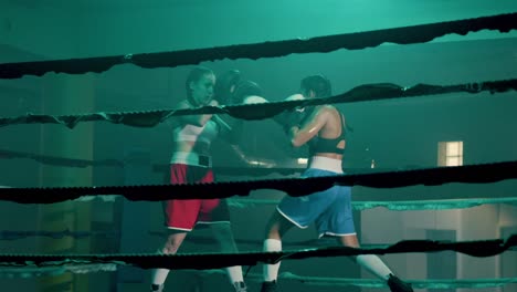 Two-Caucasian-female-boxers-training-in-boxing-gym-together