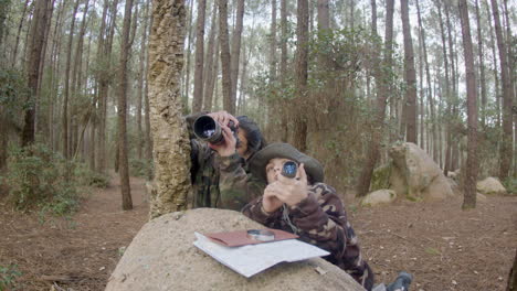 Happy-woman-and-her-son-birdwatching-in-a-natural-park
