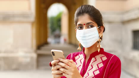 Close-up-of-a-beautiful-Indian-woman-wearing-a-surgical-mask-outdoors