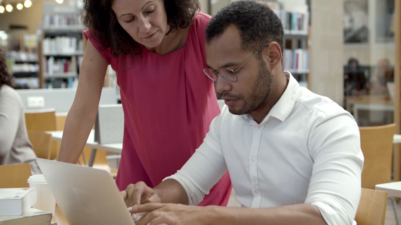 Free stock video - Side view of serious colleagues working with laptop ...