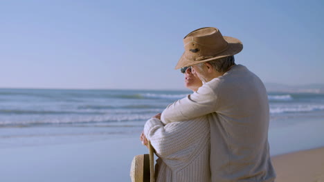 Romantic-senior-man-hugging-his-wife-from-behind-on-seashore