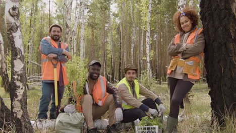 Group-of-multiethnic-ecologist-activists-posing-for-the-camera-in-the-forest