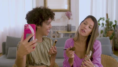 Young-Black-lady-holding-smartphone,-recording-video-with-friend