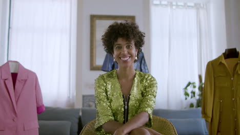 Beautiful-Black-woman-sitting-at-home,-smiling-at-camera